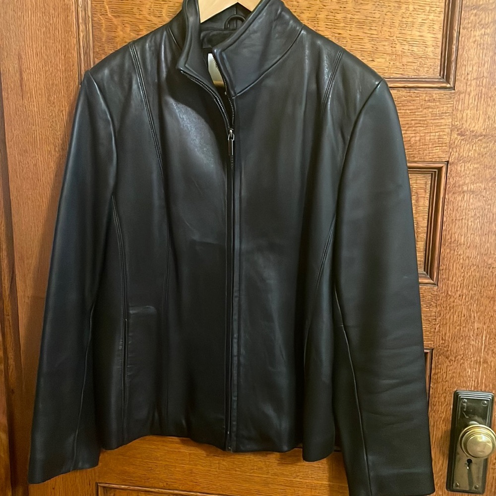 Black leather zip up jacket with clean lines, slit pockets. Nine West size L